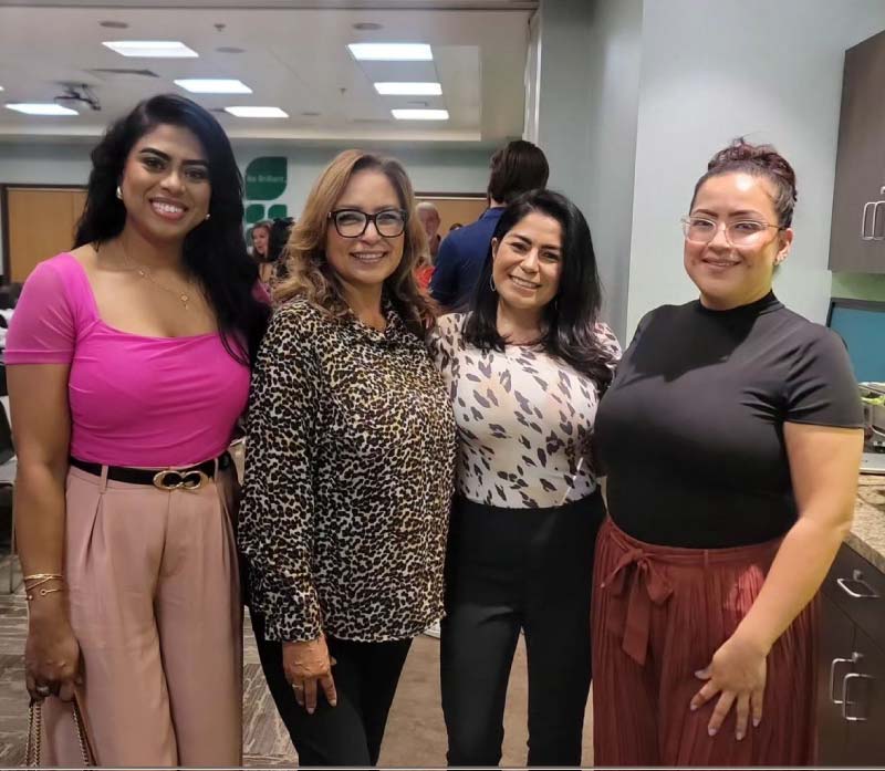 Four professional women at a networking event