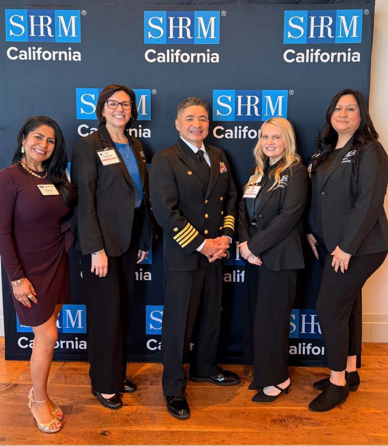 HR professionals in front of SHRM California backdrop