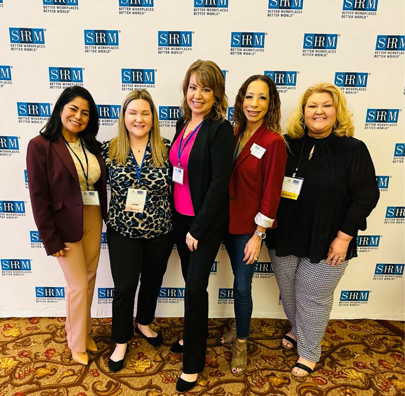 Five women in front of SHRM Better Workplaces banner